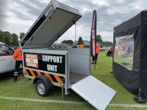 Support unit trailer with roof raised and ramp lowered